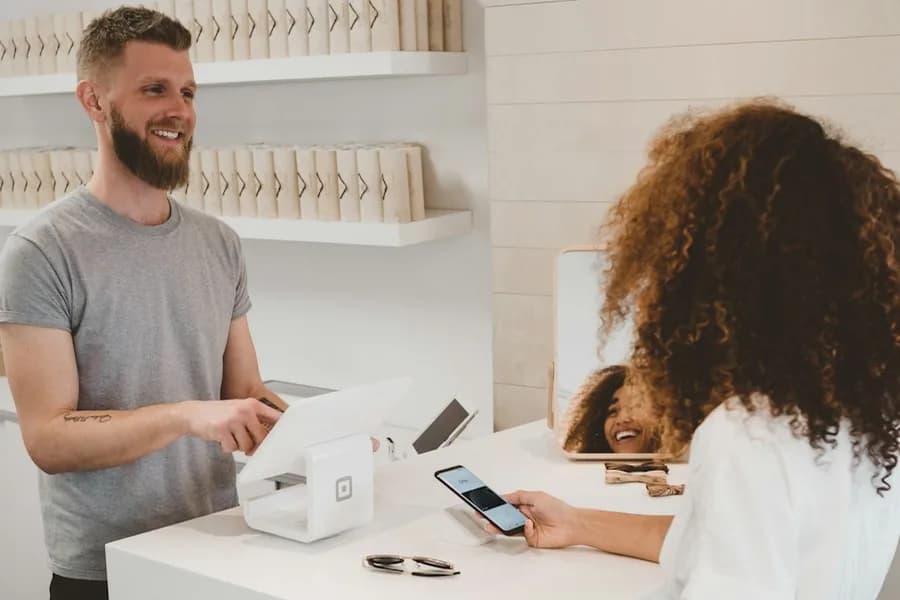 Shopper paying by phone at a retail counter