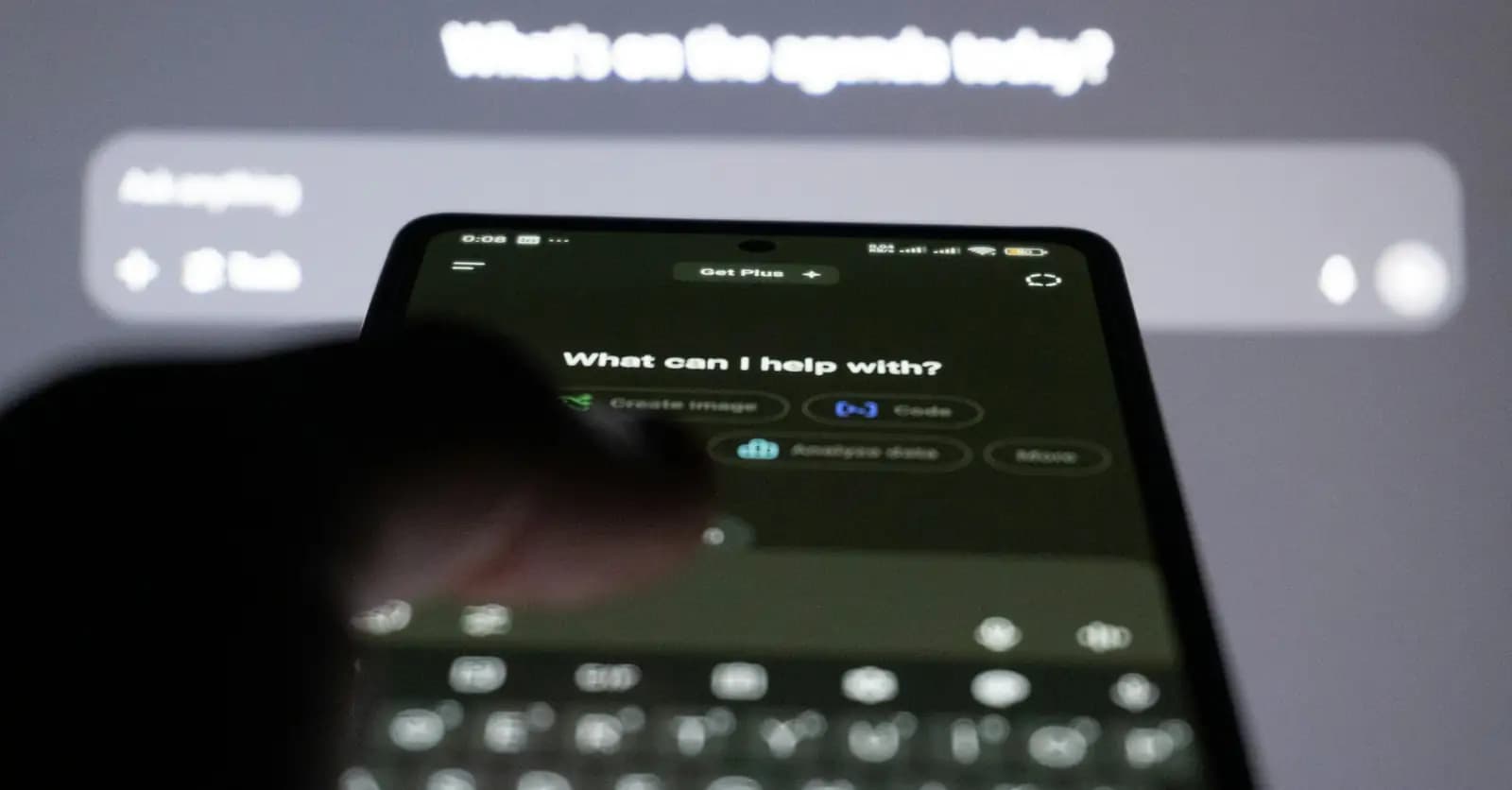 Person typing a question into an AI chatbot on a smartphone