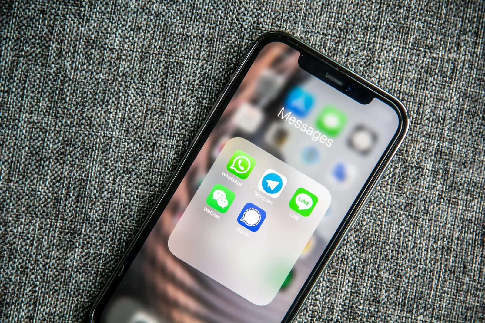 A phone showing messaging apps, representing customer support across chat channels
