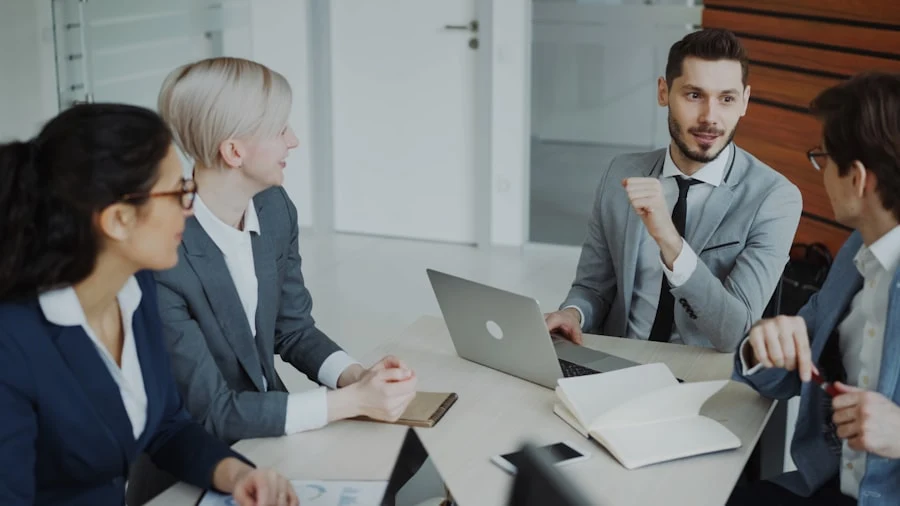 Business team collaborating around a laptop in a meeting room