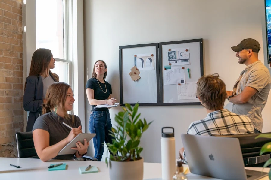 Neura Dynamics team reviewing a project plan on a whiteboard
