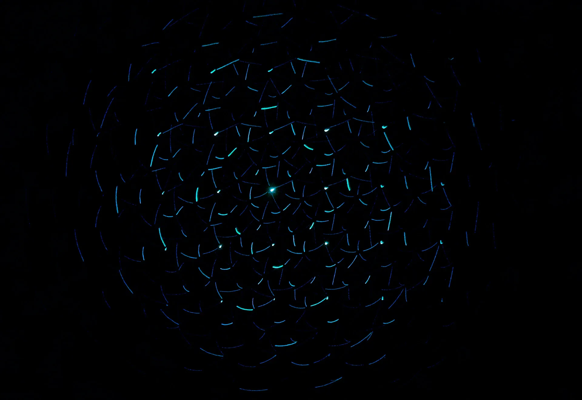 Glowing blue particle sphere on a black background